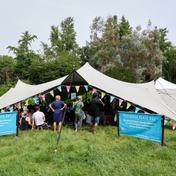 Audience gathers in The Playhouse Plays Out Tent at FloFest