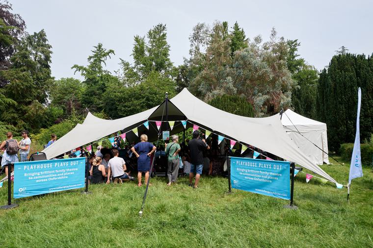 Audience gathers in The Playhouse Plays Out Tent at FloFest