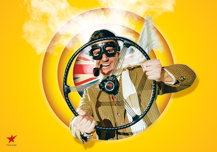 A man in a yellow roundel holding an old fashioned steering wheel. He has a pipe in his mouth and wears a tweed jacket with driving goggles on. A Union Jack is placed behind him.