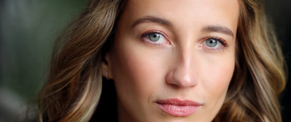 India Shaw Smith in a grey top against a green background.
