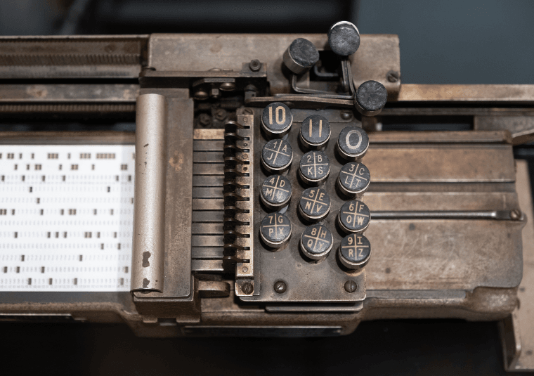 Punch card machine with card and old fashioned metal keys at The Intelligence Factory at Bletchley Park