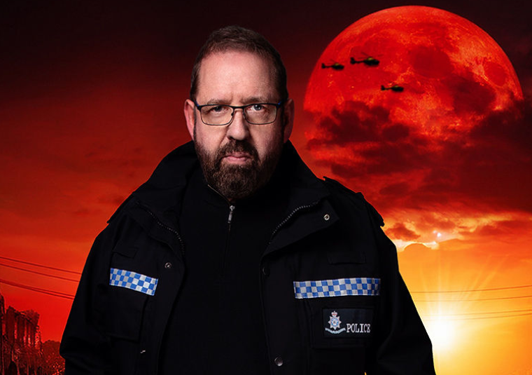 Comedian Alfie Moore in a police uniform with a background of the apocalypse with a bright red moon and silhouettes of military helicopters.