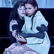 Fairy Queen Titania and the Child sat in an embrace.