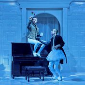 Oberon and Puck discussing their mischievous plan as Oberon holds a flower in front of him.