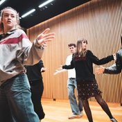 Company cast in rehearsals.