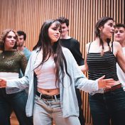 Company cast in rehearsals