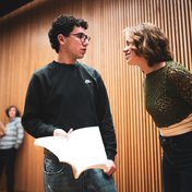 Company cast in rehearsals.