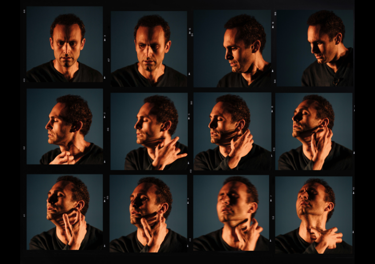 Multiple images of Khalid Abdalla in an almost stop motion film strip of him facing the camera, moving to a portrait side profile and reaching up with his hand grasping his neck.