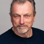 Philip Rham profile image against a grey background.