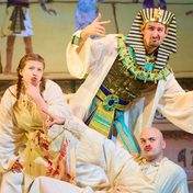 An actor dressed as a pharaoh and two actors dressed as servants strike a funny pose.