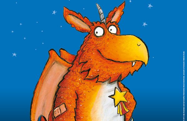 Zog the dragon is pictured with a star badge and elbow plaster, smiling, in an illustration from the story.