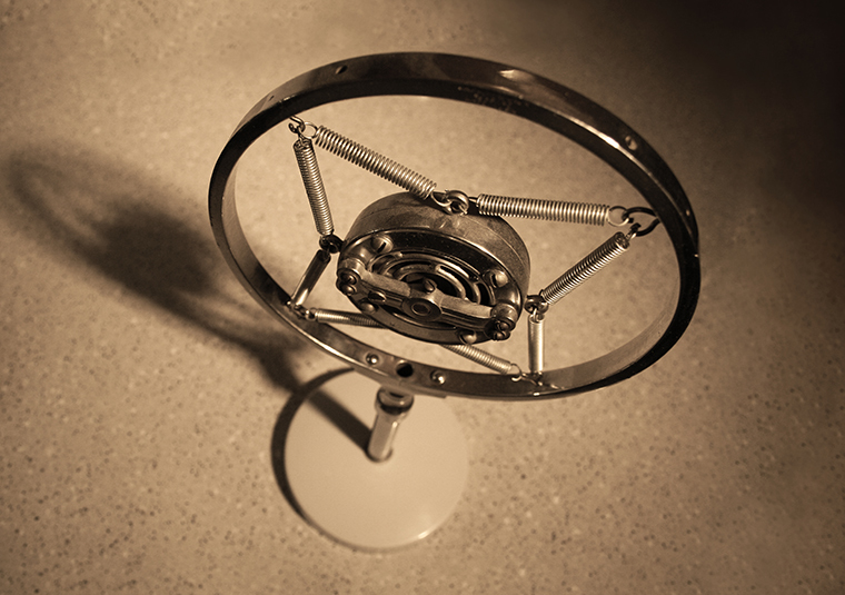 A vintage microphone sat on a desk.