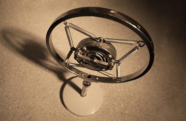 A vintage microphone sat on a desk.