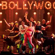 The cast of Frankie Goes to Bollywood in workout clothing during a dance scene.