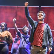 A group of people with their fists in the air.