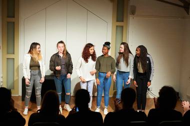 A group of teenagers performing a Play