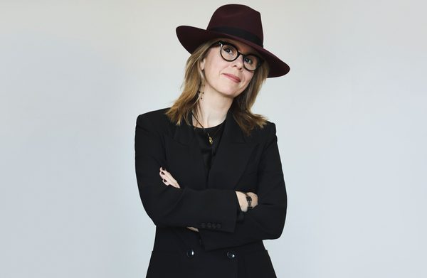 Performer wearing a hat and looking at camera