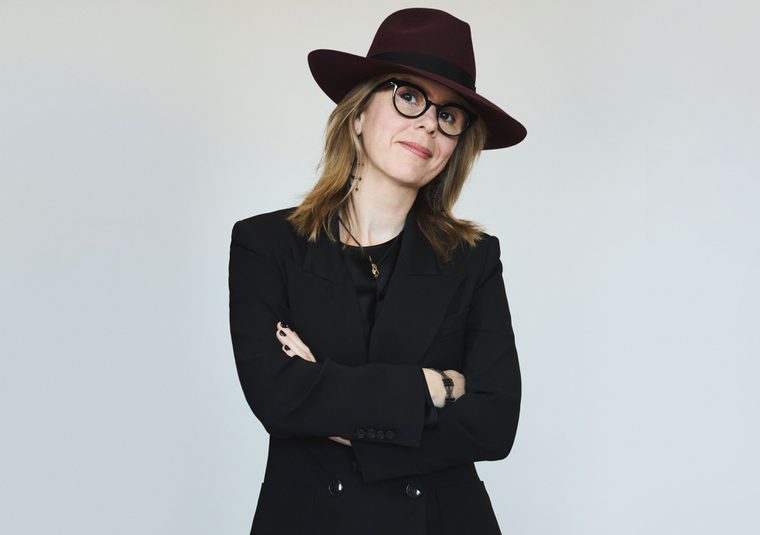 Performer wearing a hat and looking at camera