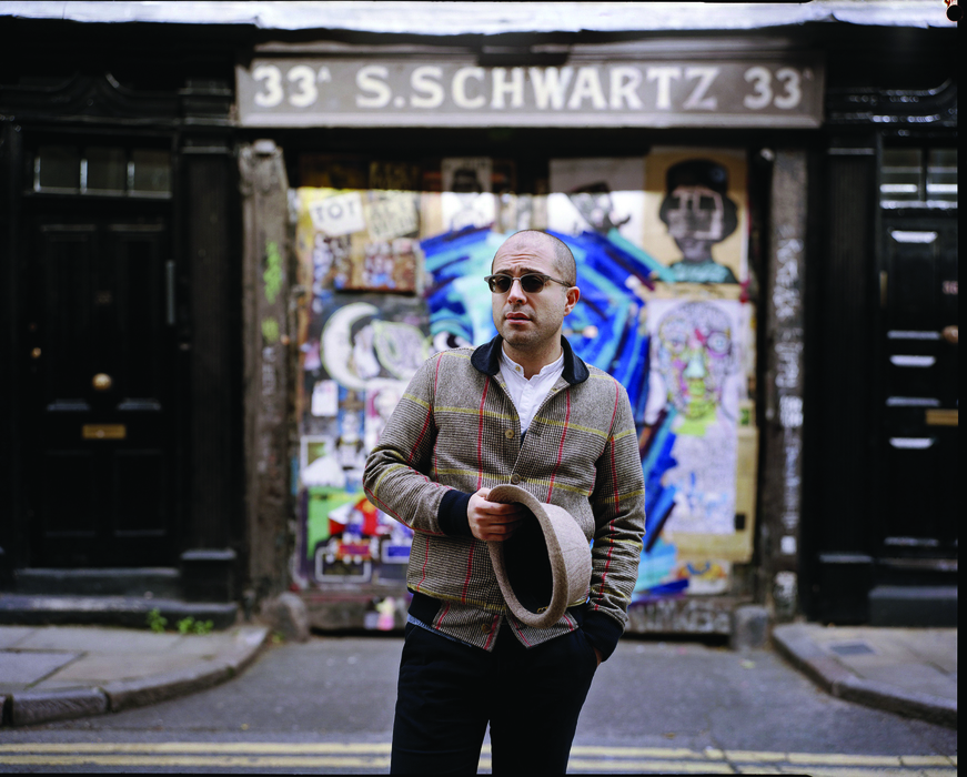 The performer standing in front of a building