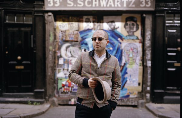 The performer standing in front of a building