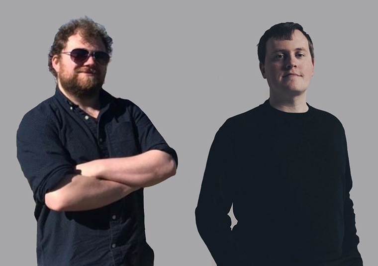 The performers standing against a gray background, facing the camera