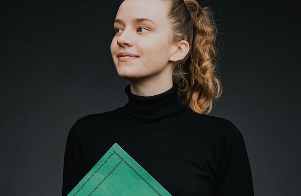 The performer holding a folder