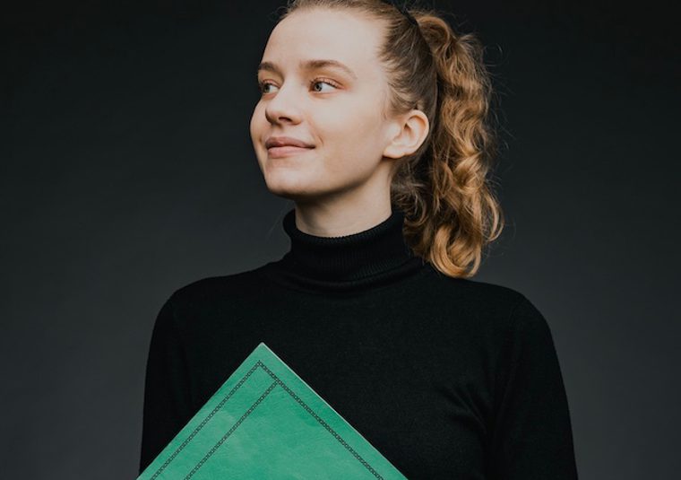 The performer holding a folder