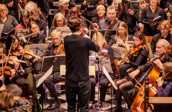 The orchestra performing with their instruments