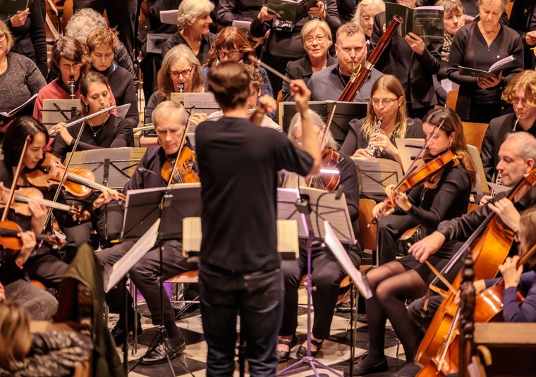 The orchestra performing with their instruments