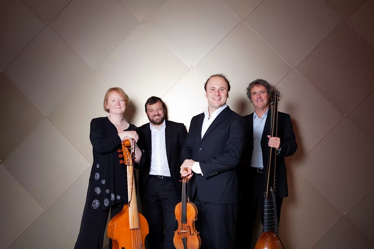A group of performers standing with their instruments