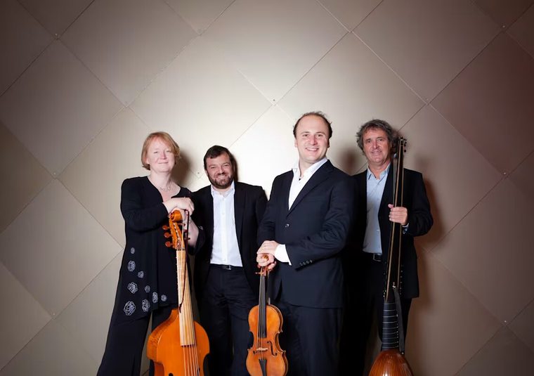 A group of performers standing with their instruments