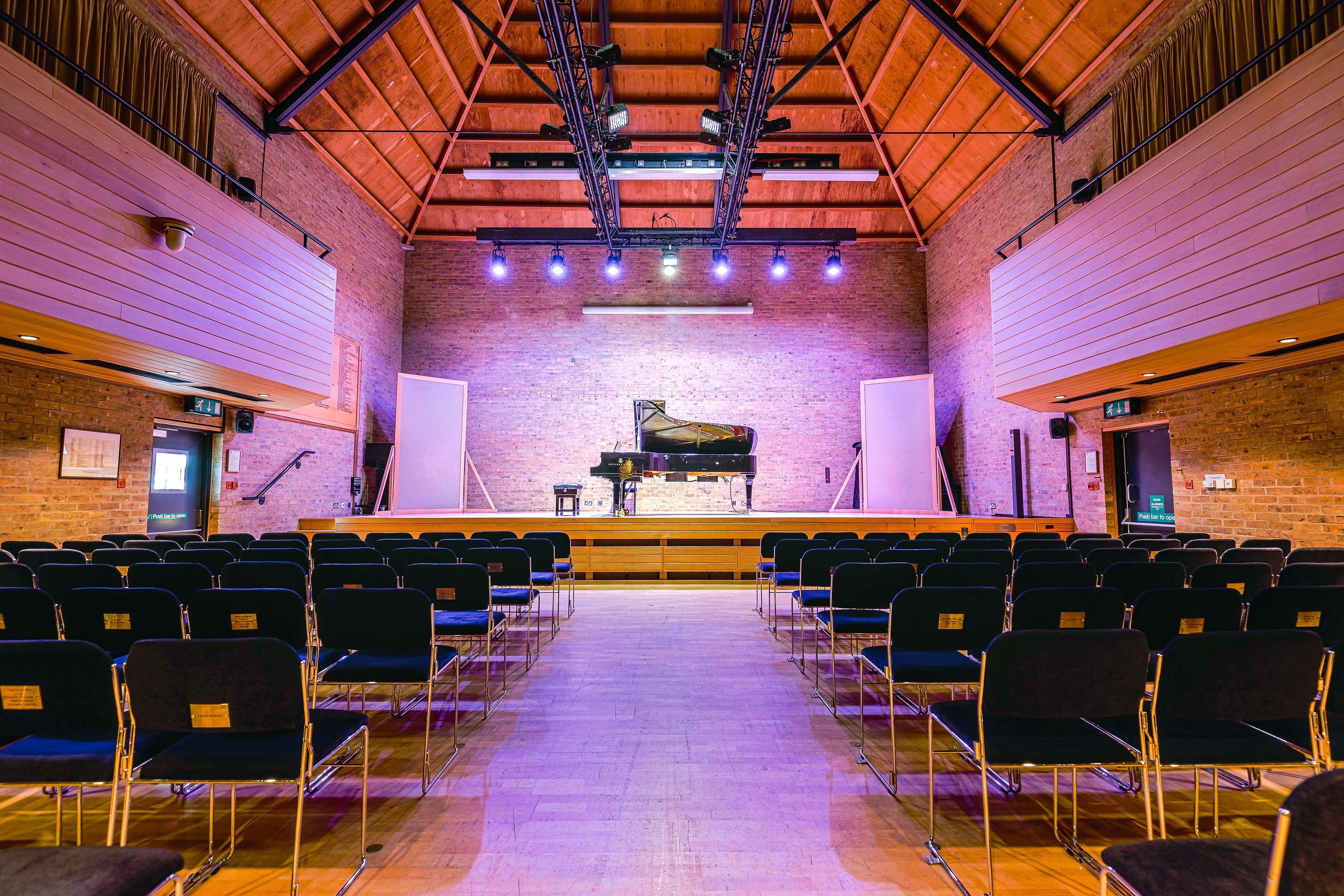 The interior of the JdP Music Building set for a concert with piano on-stage