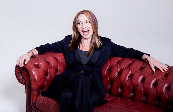 The performer sitting on a sofa