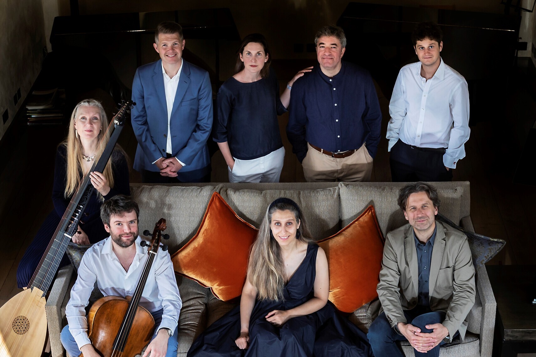 A group of performers sitting with their instruments