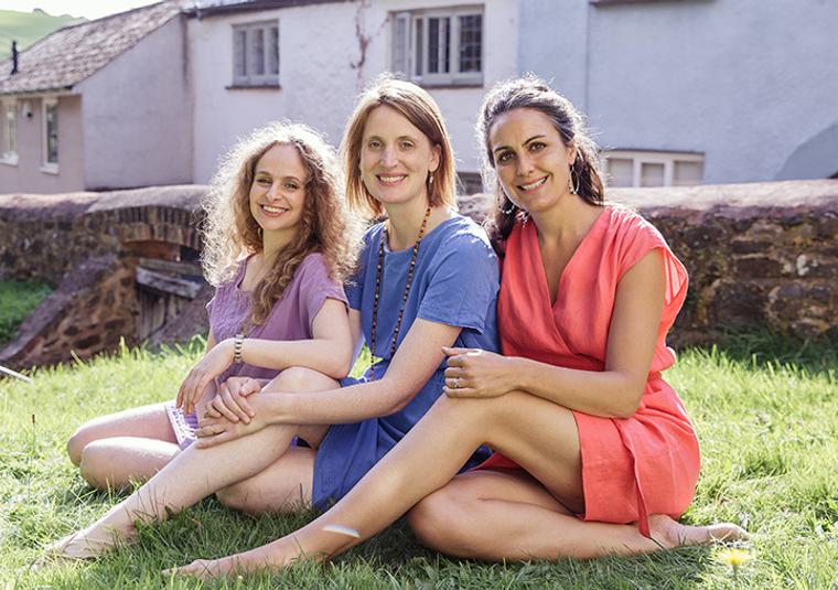 Performers sitting on a lawn