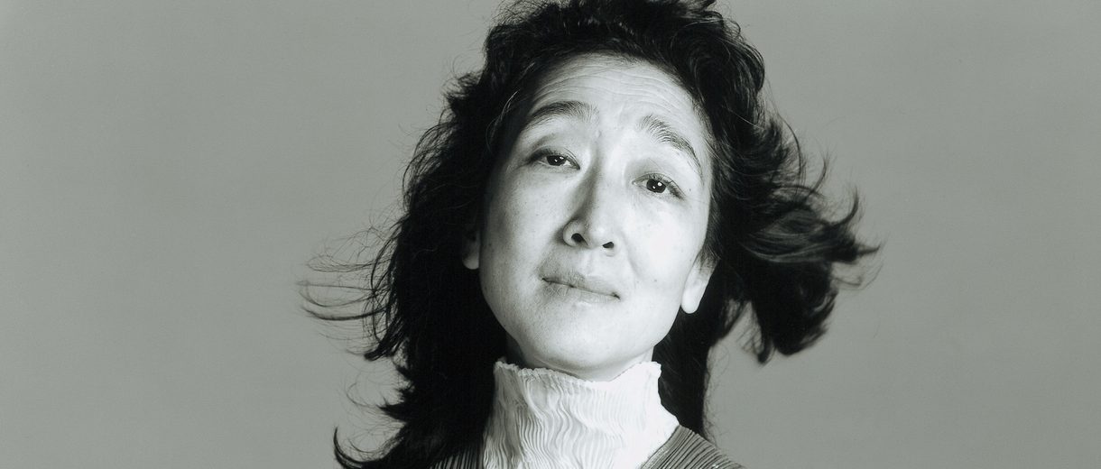 Performer standing against a gray background