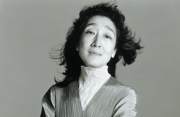 Performer standing against a gray background