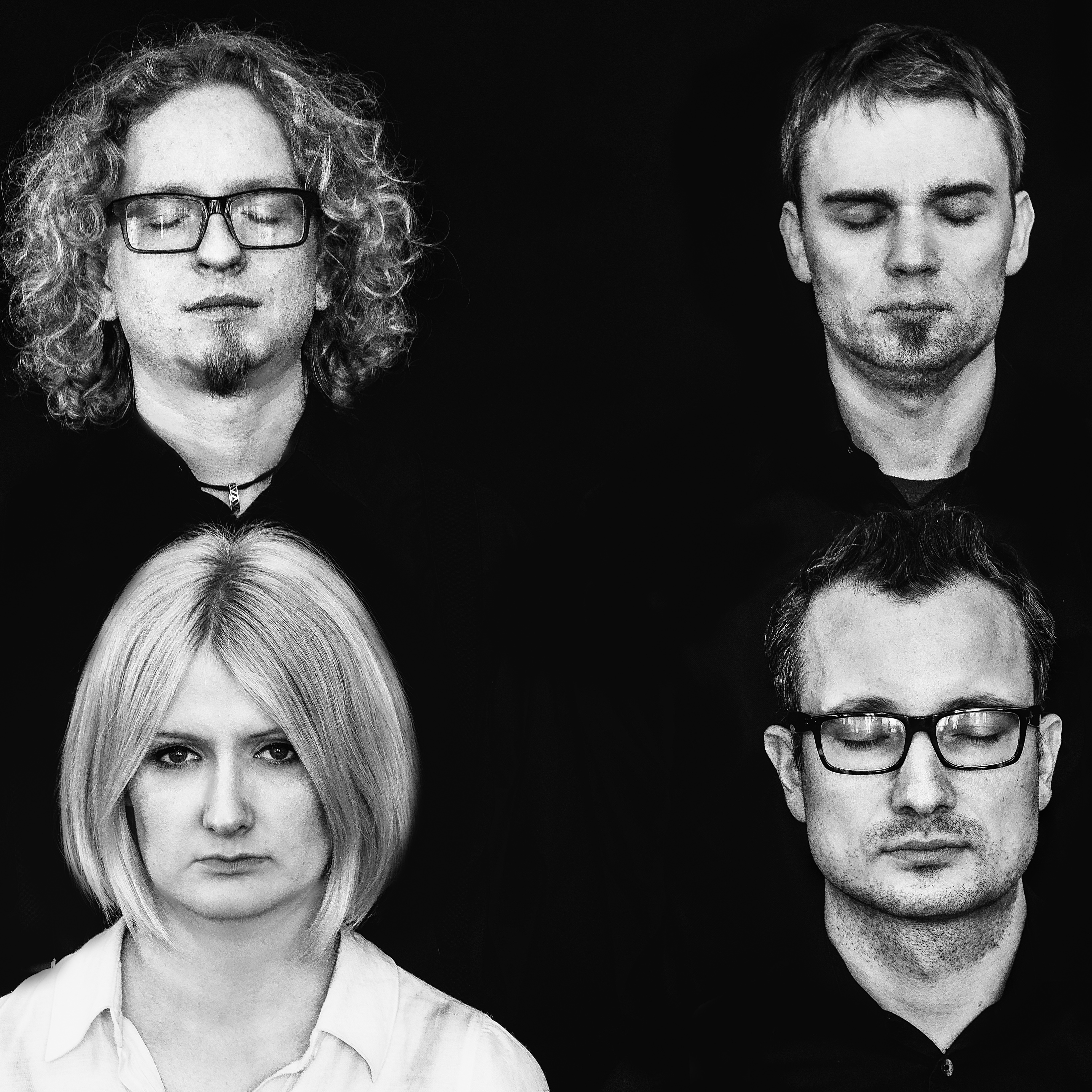 Four performers looking at camera against a black background