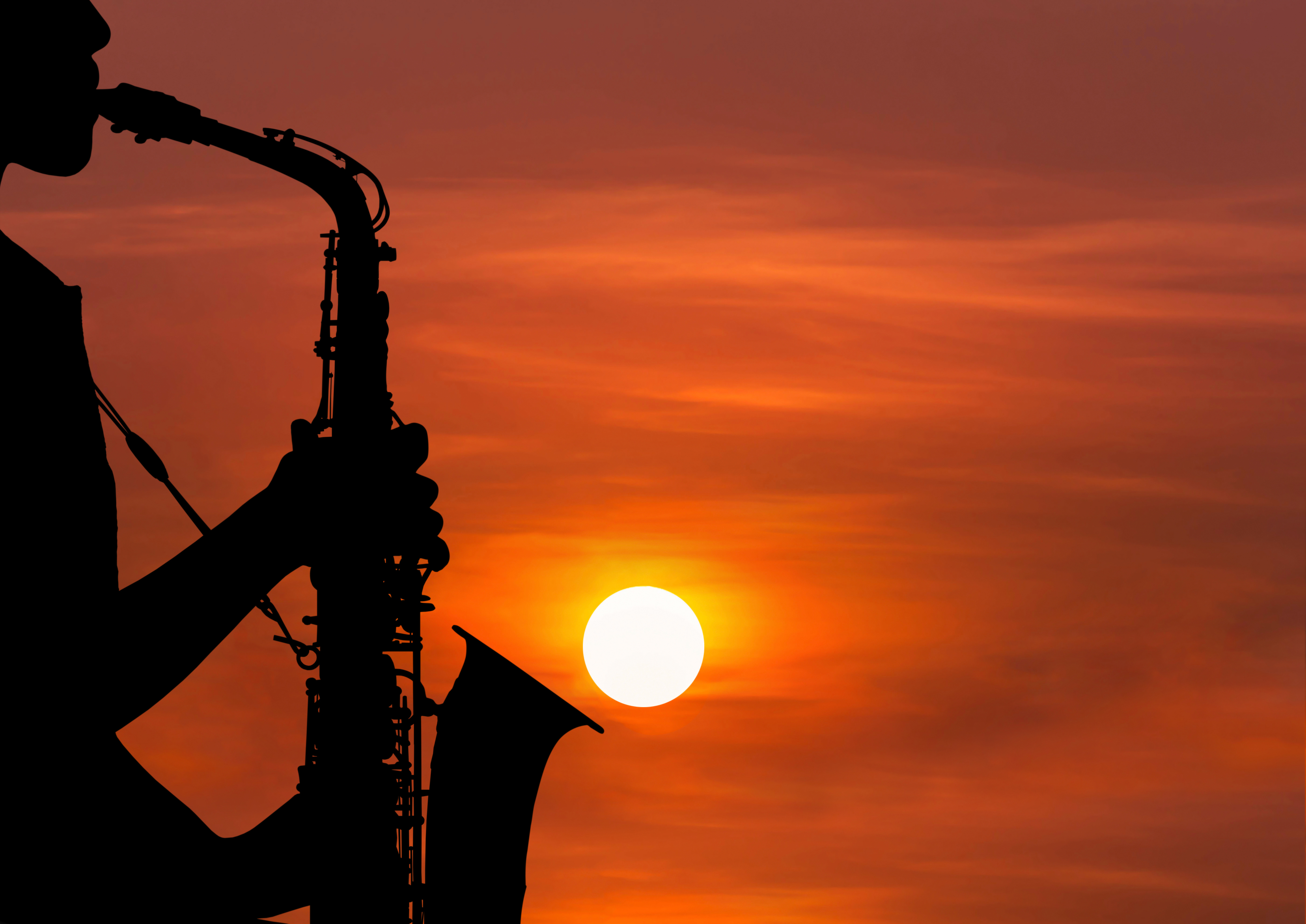 An instrument being played against a setting sun