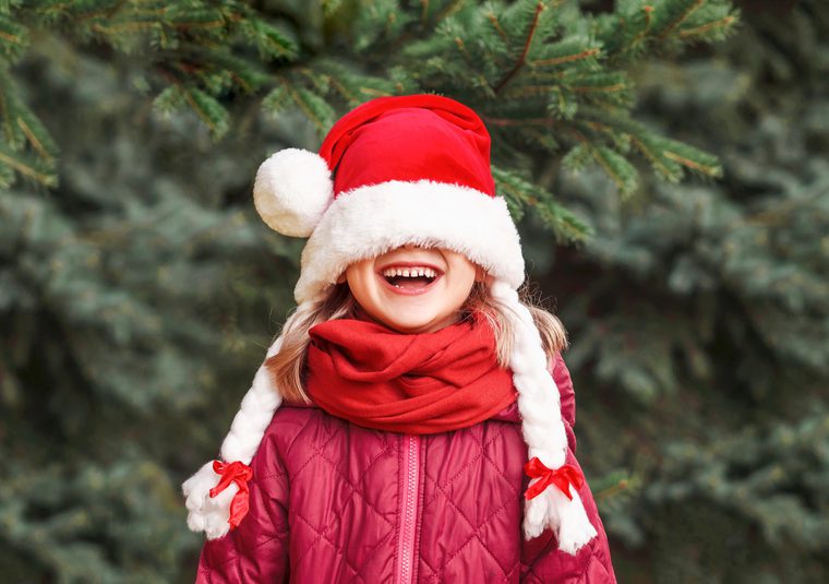 A child wearing a Christmas hat