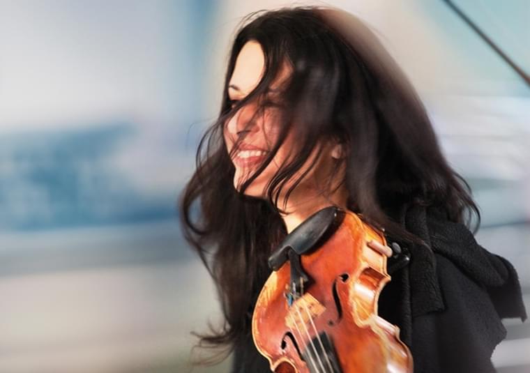A performer holding a violin
