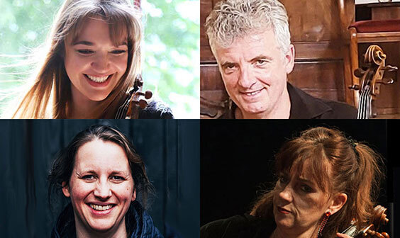 The performers looking at the camera, some of them holding instruments