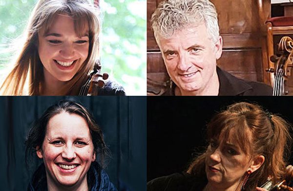 The performers looking at the camera, some of them holding instruments