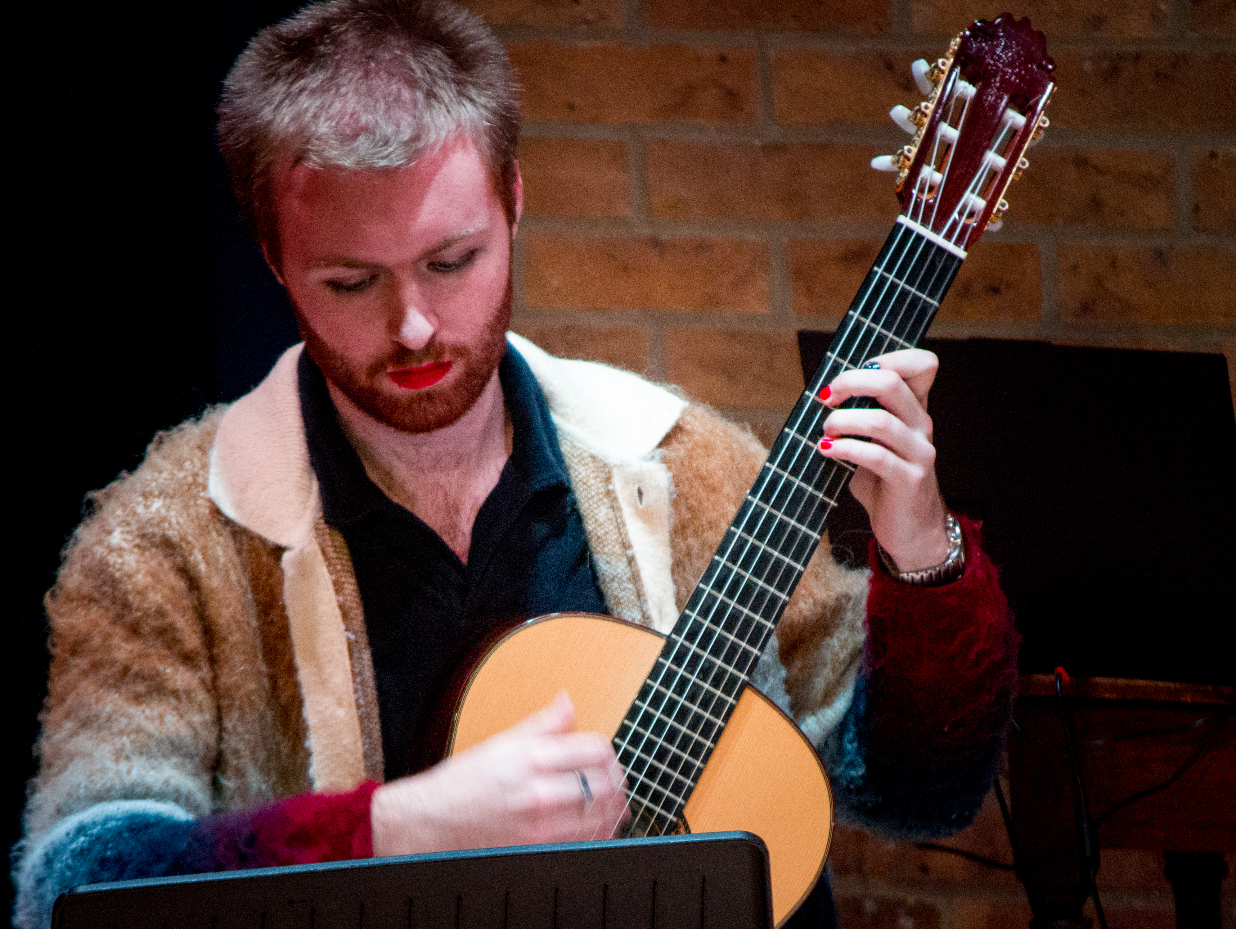 Performer holding guitar