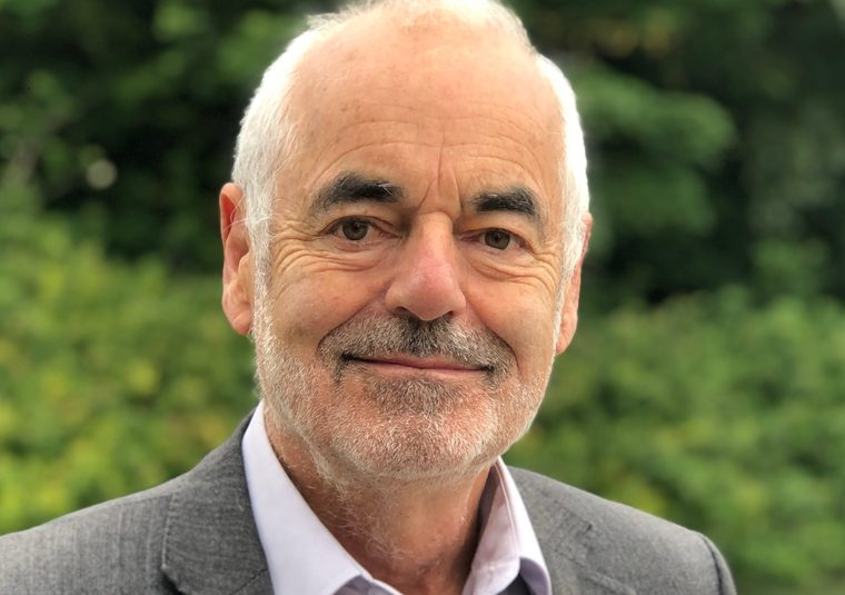 Guest speaker in a garden looking at the camera