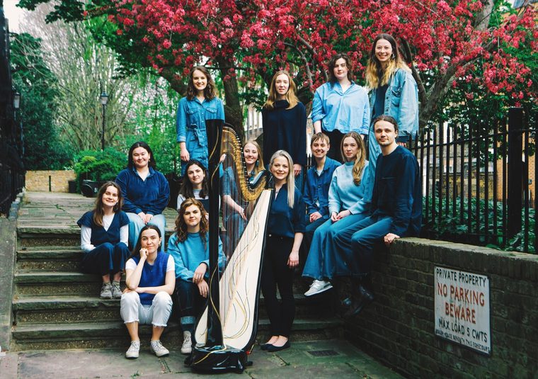 The performers gathered around a wall and steps