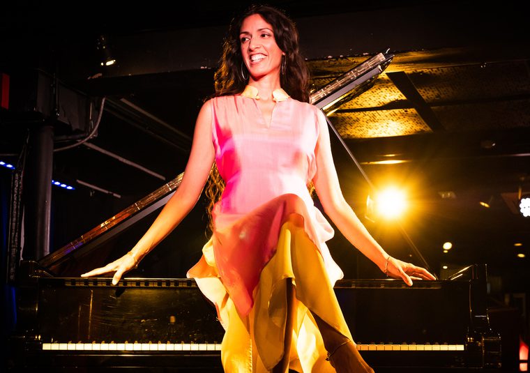 Performer sitting on a piano